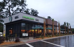 A starbucks is shown on the side of the road.