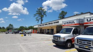 A u-haul truck parked in front of a store.